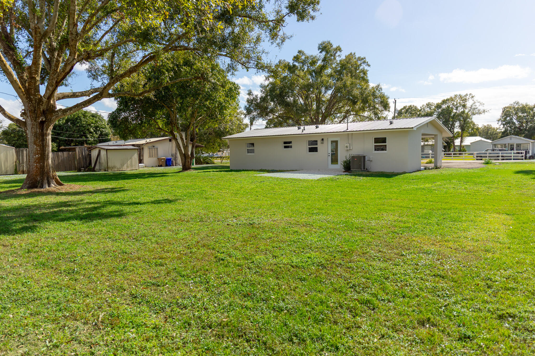 1008 Southwest 10th Street Okeechobee, FL 34974 - Photo 23 of 41 a house with a tree in front of it