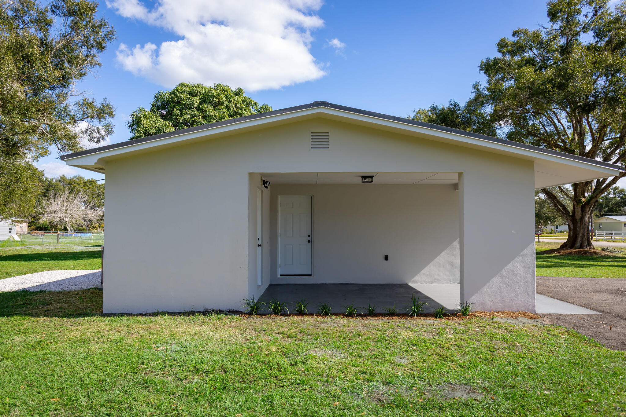 1008 Southwest 10th Street Okeechobee, FL 34974 - Photo 25 of 41 a view of an house with backyard space and garden