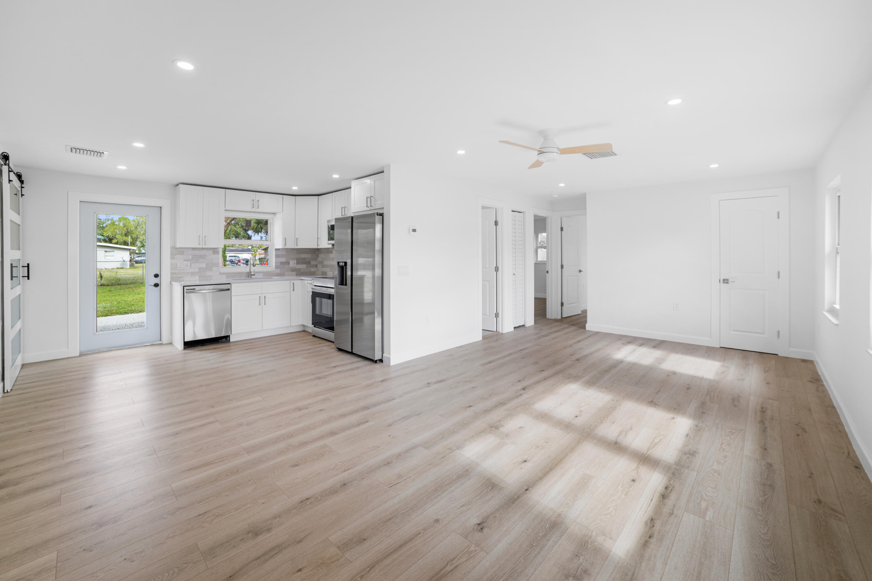 1008 Southwest 10th Street Okeechobee, FL 34974 - Photo 3 of 41 a view of a kitchen with a sink and a refrigerator