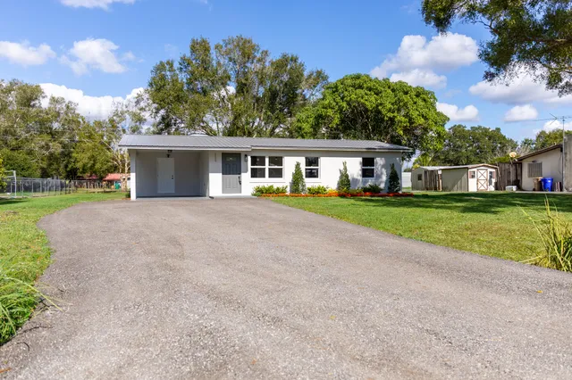 a view of house with outdoor space and garden