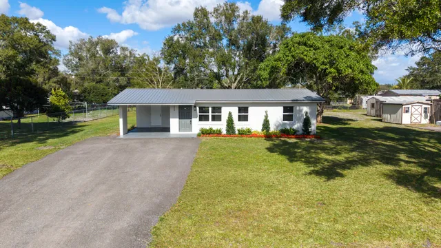 a front view of a house with a yard table and chairs