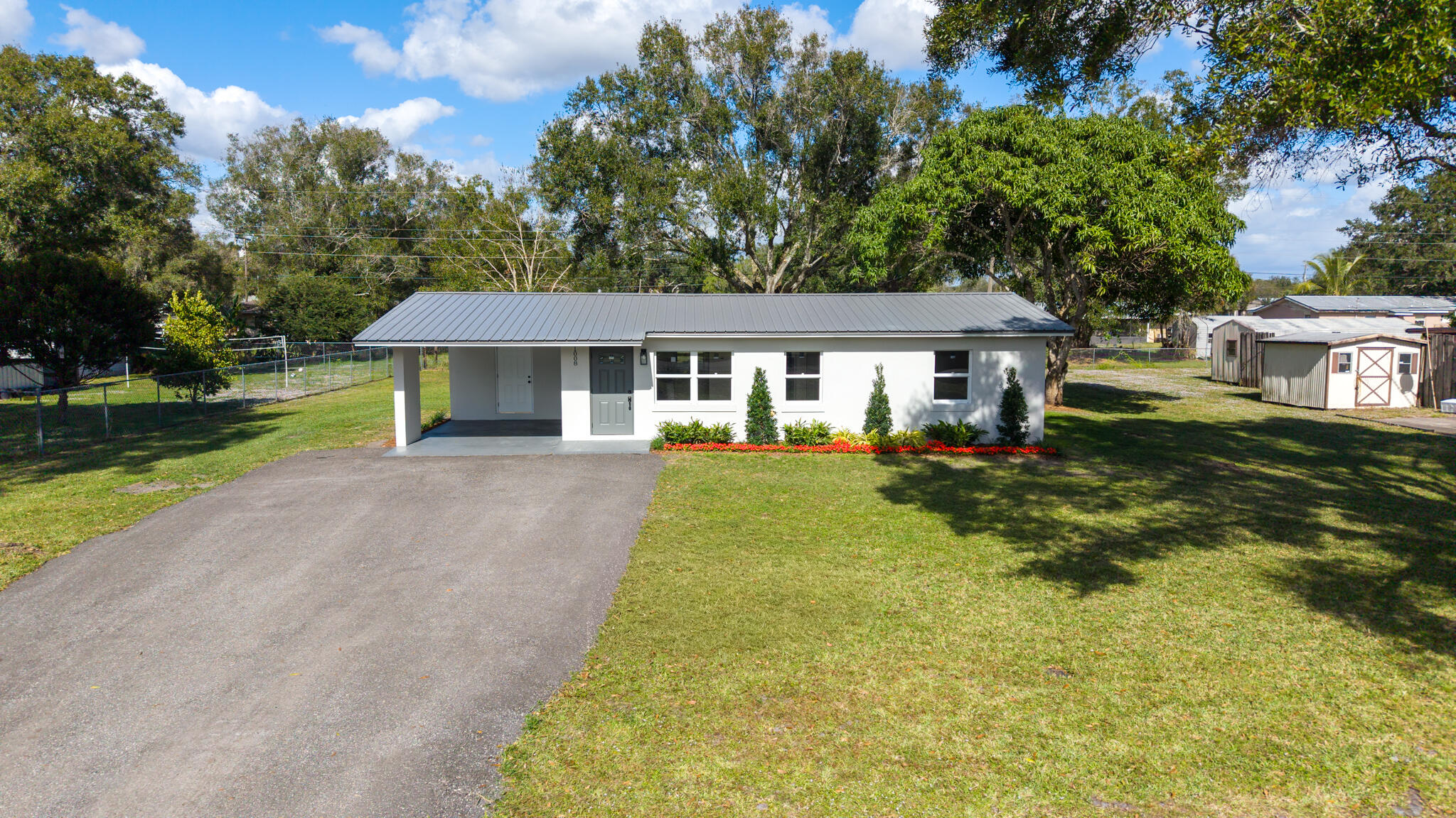 1008 Southwest 10th Street Okeechobee, FL 34974 - Photo 40 of 41 a front view of a house with a yard table and chairs