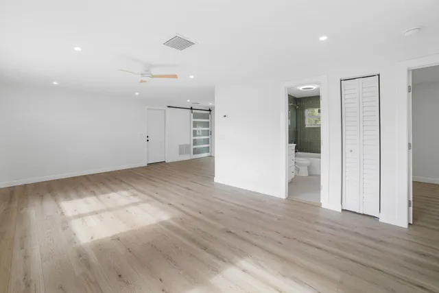 a view of empty room with wooden floor
