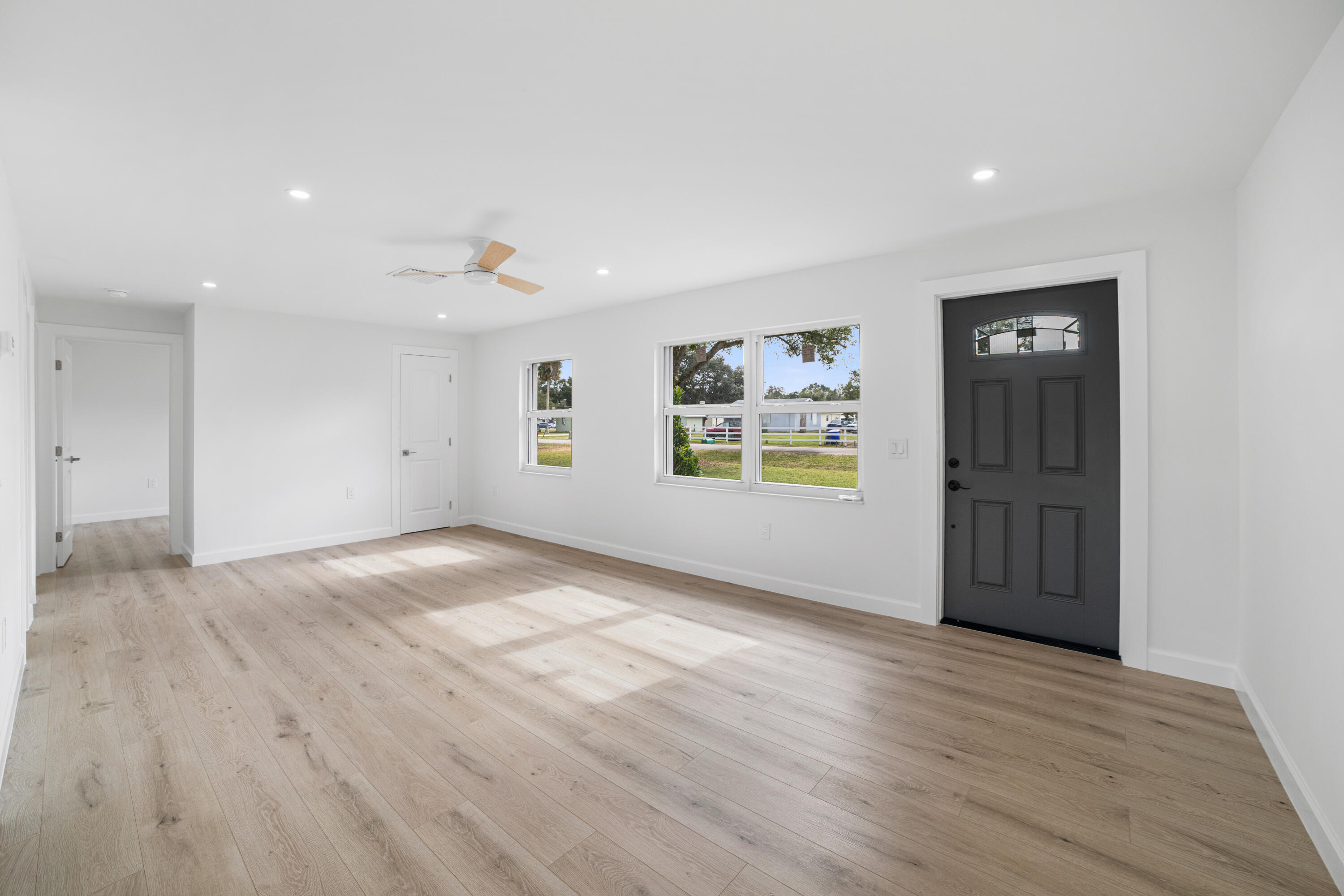 1008 Southwest 10th Street Okeechobee, FL 34974 - Photo 6 of 41 wooden floor in an empty room with a window