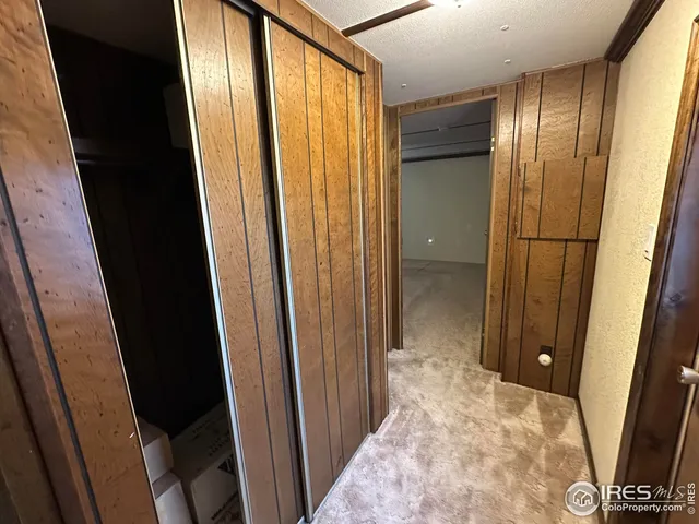a view of hallway with a window and a wooden floor