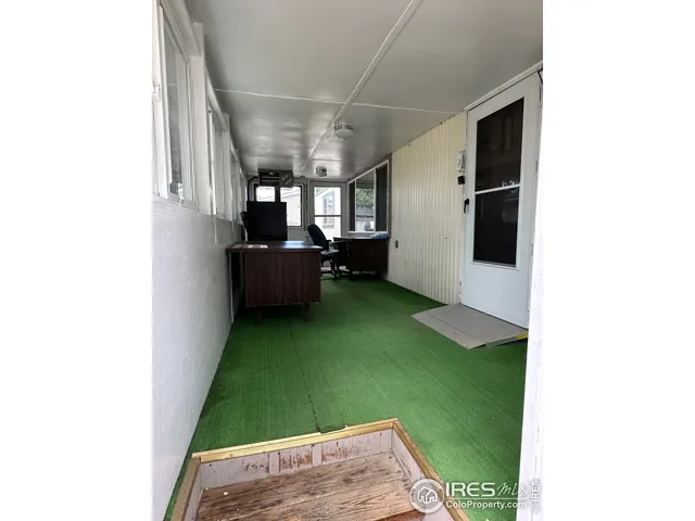 a view of an empty room with kitchen