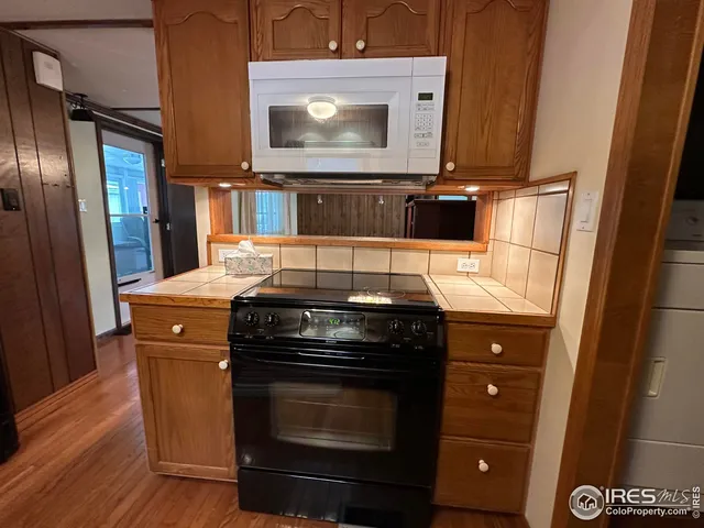 a kitchen with a stove and a refrigerator