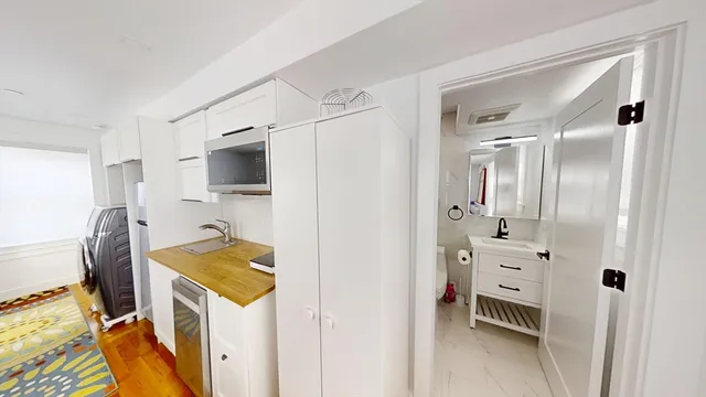 a view of kitchen with furniture and wooden floor