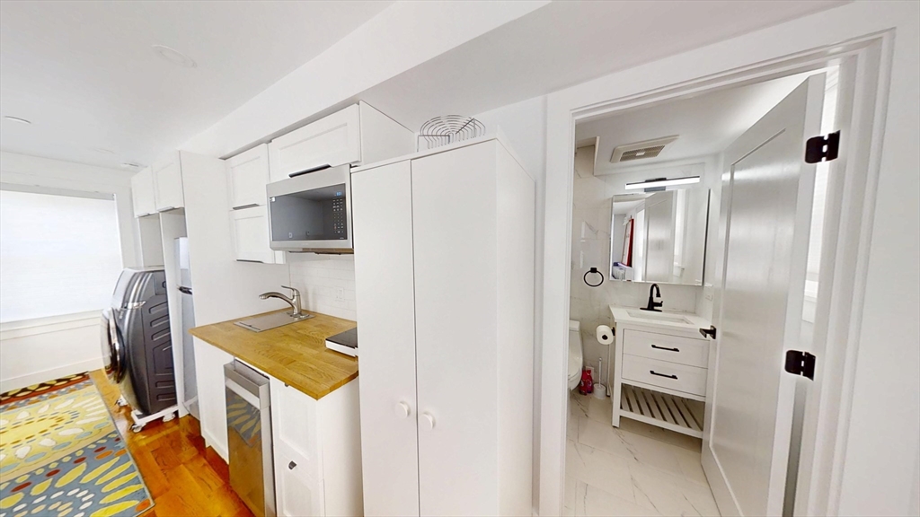 36 Shepard Street, Unit 2 Boston, MA 02135 - Photo 12 of 29 a view of kitchen with furniture and wooden floor