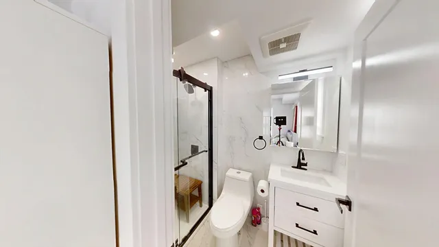 a bathroom with a sink mirror and tub