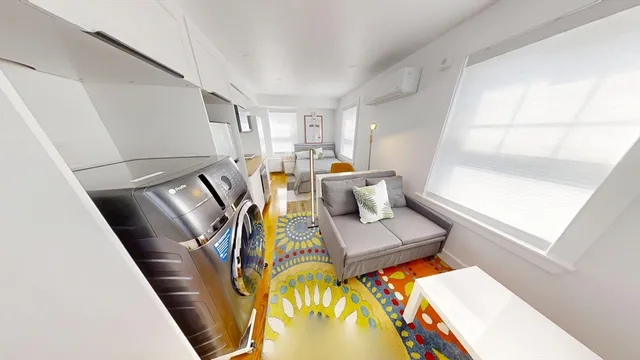 a living room with furniture and a floor to ceiling window