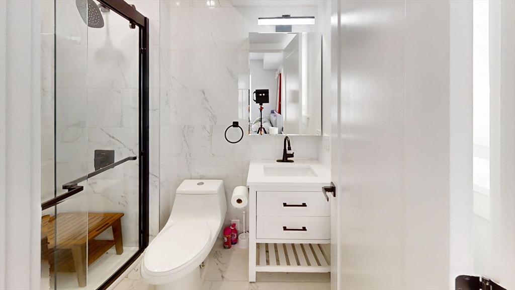 36 Shepard Street, Unit 2 Boston, MA 02135 - Photo 20 of 29 a bathroom with a sink and a mirror