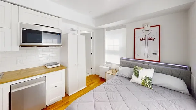 a bedroom with a bed and a television