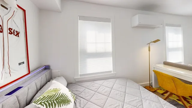 a bedroom with a bed and a window