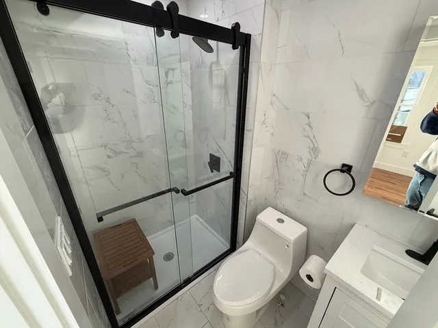 a bathroom with a toilet and a shower