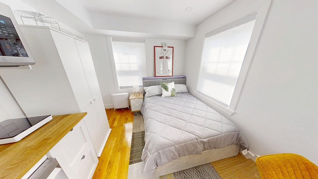 36 Shepard Street, Unit 2 Boston, MA 02135 - Photo 4 of 29 a bedroom with a bed and wooden floor