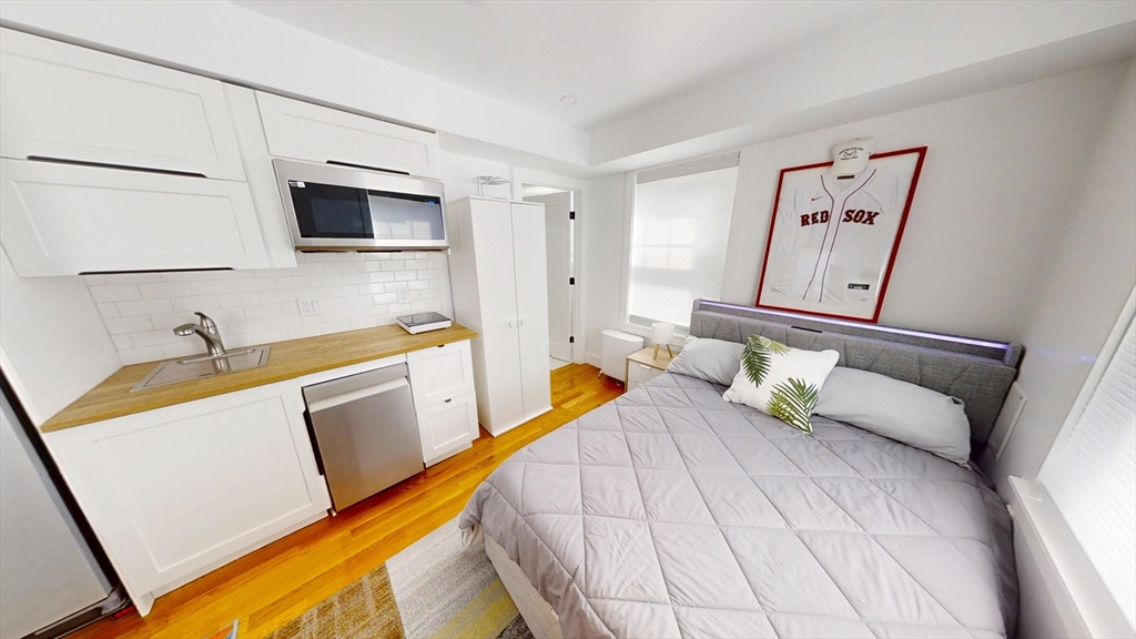 36 Shepard Street, Unit 2 Boston, MA 02135 - Photo 5 of 29 a bedroom with a bed and a flat screen tv