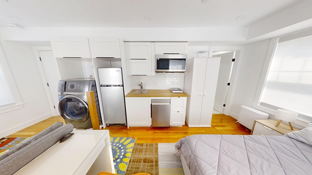 36 Shepard Street, Unit 2 Boston, MA 02135 - Photo 6 of 29 a bedroom with a bed and utility room