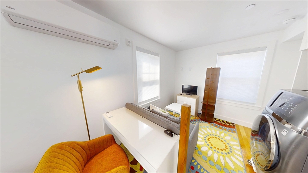 36 Shepard Street, Unit 2 Boston, MA 02135 - Photo 9 of 29 a bedroom with a bed and wooden floor