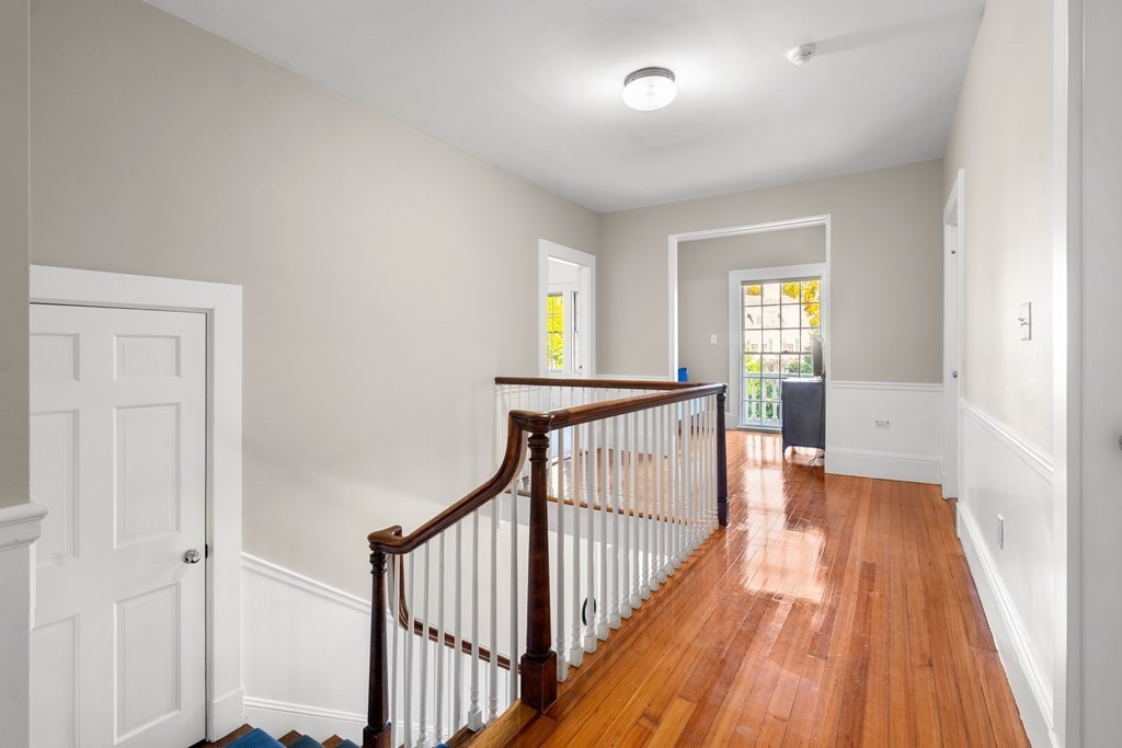 9 Livermore Road Wellesley, MA 02481 - Photo 15 of 20 a view of a hallway with wooden floor and a living room