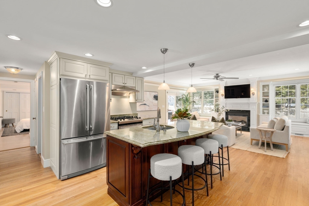 6 Boulder Brook Road Wellesley, MA 02481 - Photo 8 of 34 a kitchen with stainless steel appliances granite countertop a refrigerator a stove a sink a dining table and chairs with wooden floor