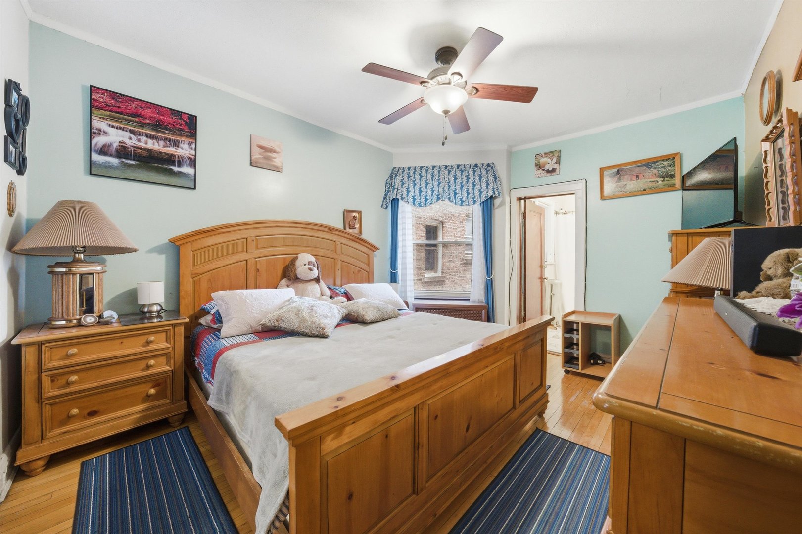 8019 South Rhodes Avenue Chicago, IL 60619 - Photo 11 of 55 a bedroom with a bed and a chandelier