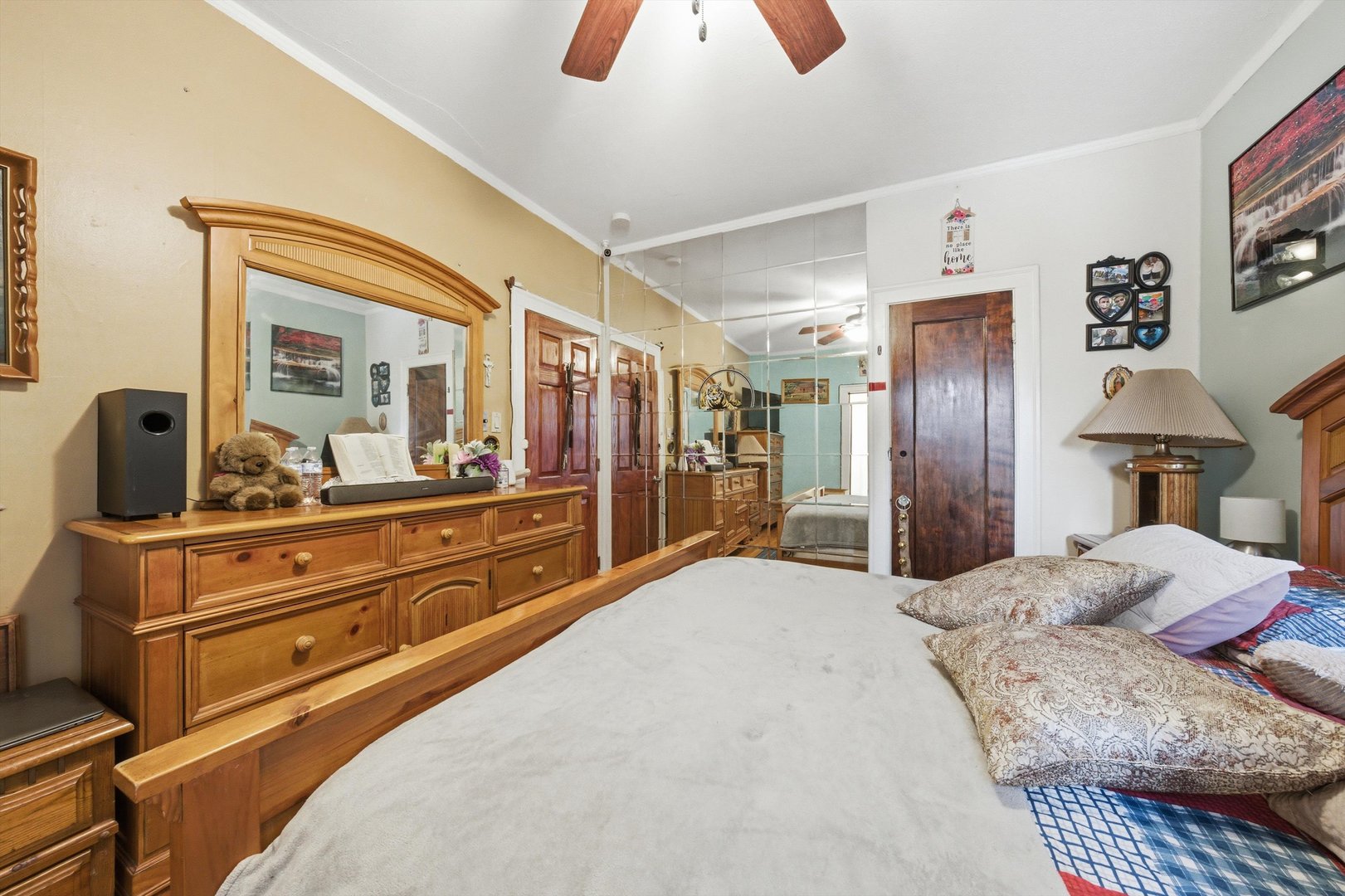 8019 South Rhodes Avenue Chicago, IL 60619 - Photo 12 of 55 a bedroom with a large bed and a large mirror on dresser