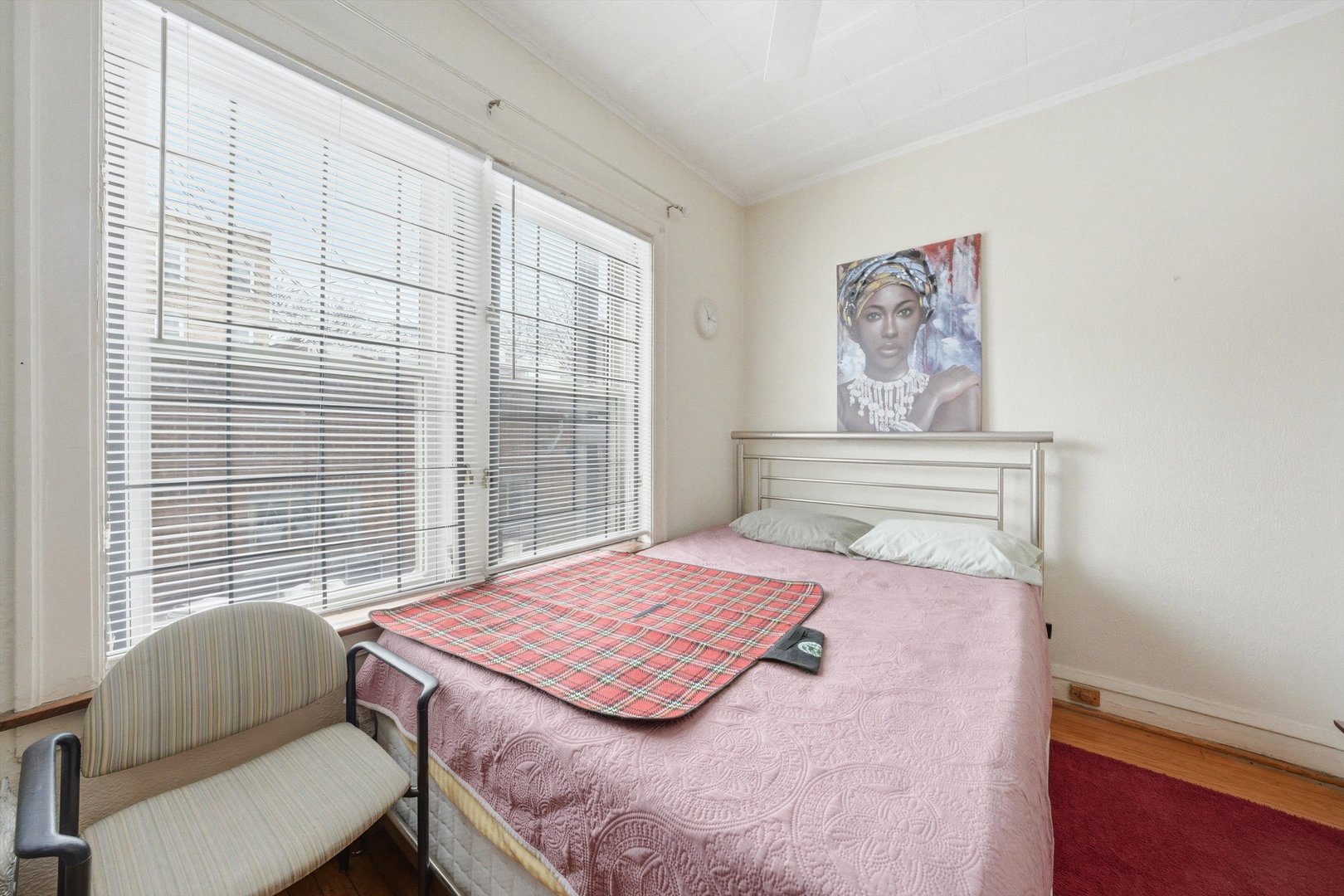 8019 South Rhodes Avenue Chicago, IL 60619 - Photo 13 of 55 a bedroom with a bed and a chair