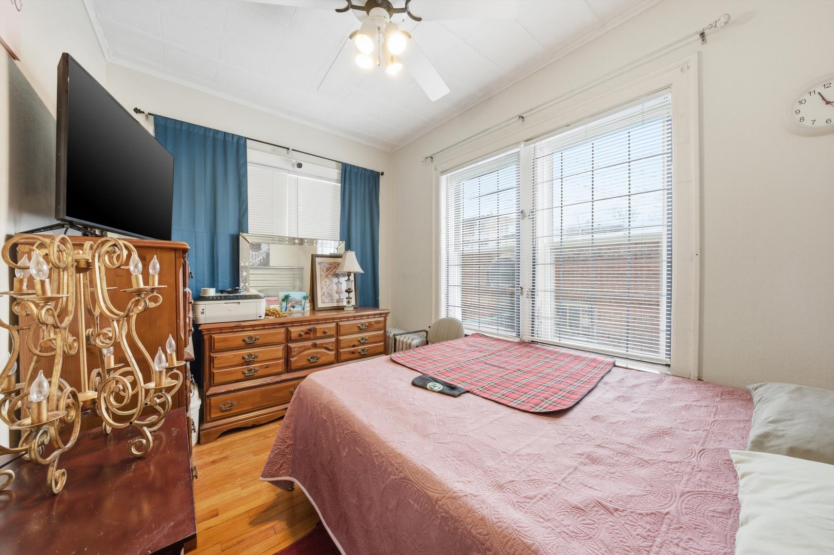 8019 South Rhodes Avenue Chicago, IL 60619 - Photo 14 of 55 a bedroom with a large bed and a flat tv screen on dresser