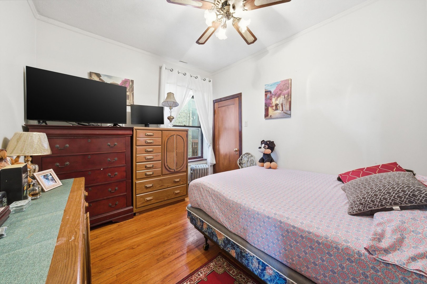 8019 South Rhodes Avenue Chicago, IL 60619 - Photo 15 of 55 a bedroom with a bed and flat screen tv