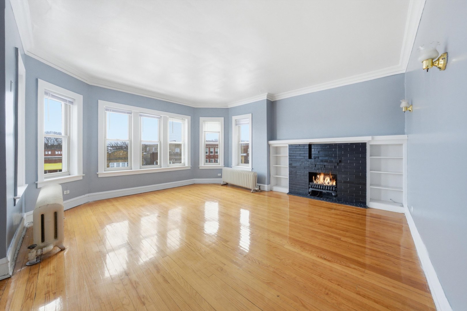 8019 South Rhodes Avenue Chicago, IL 60619 - Photo 19 of 55 a view of an empty room with wooden floor and a window