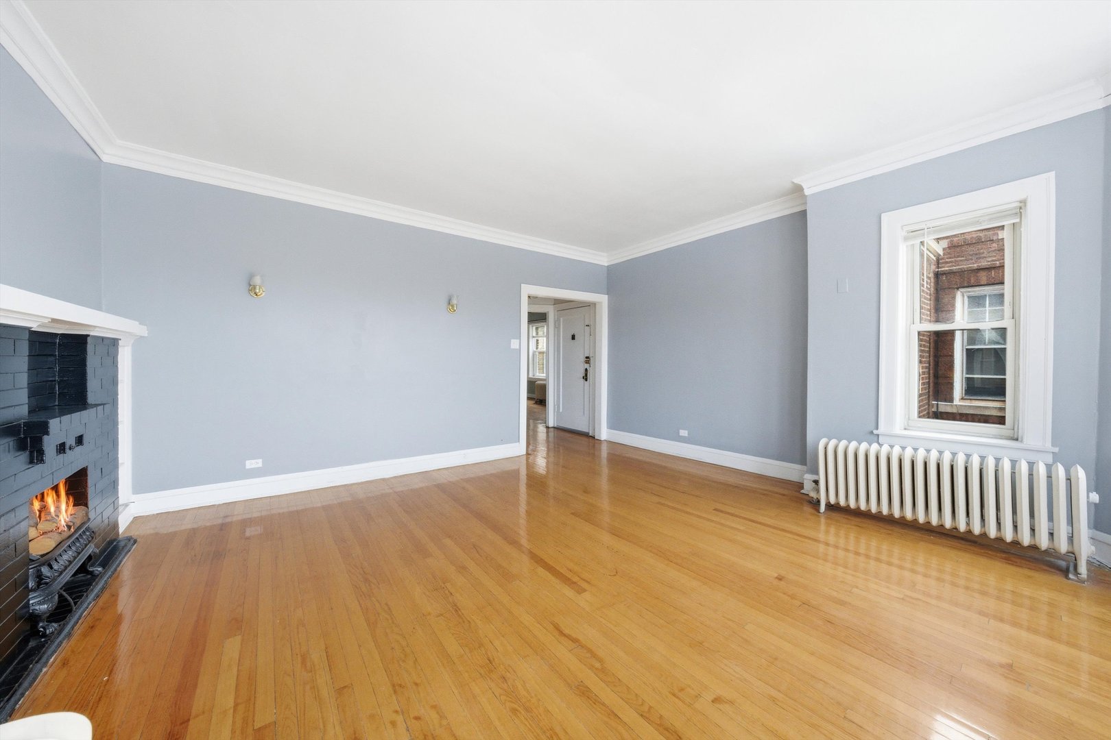 8019 South Rhodes Avenue Chicago, IL 60619 - Photo 20 of 55 an empty room with wooden floor and windows