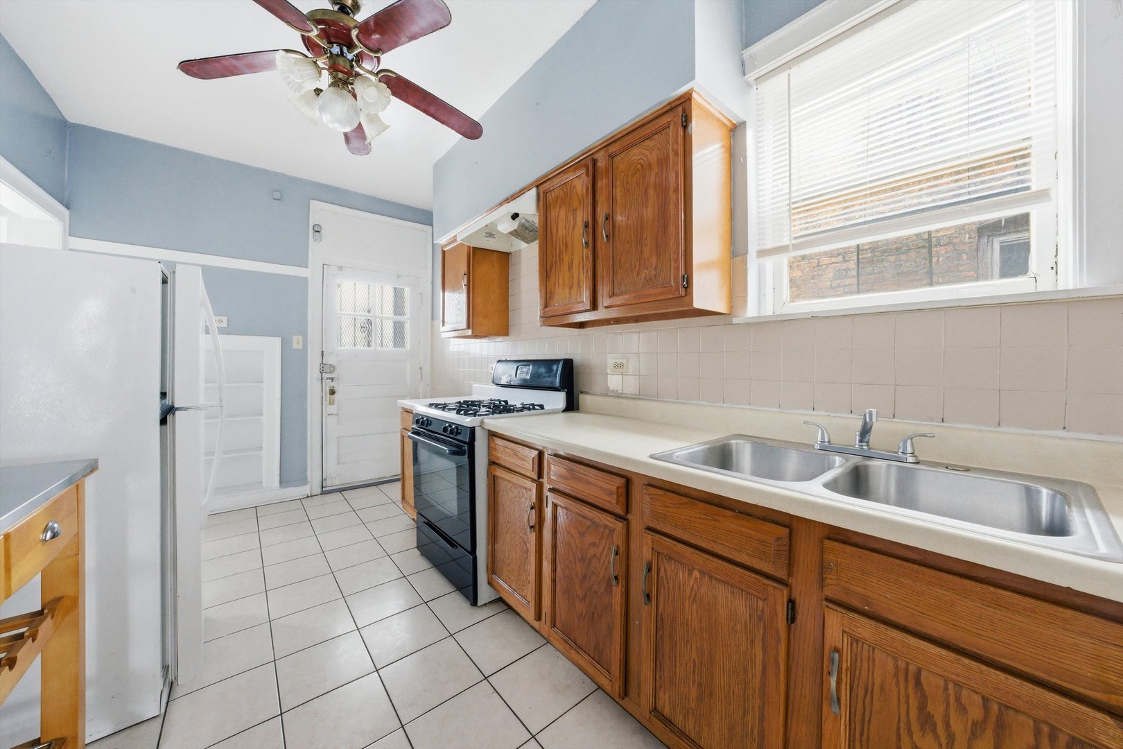 8019 South Rhodes Avenue Chicago, IL 60619 - Photo 22 of 55 a kitchen with a sink cabinets and window