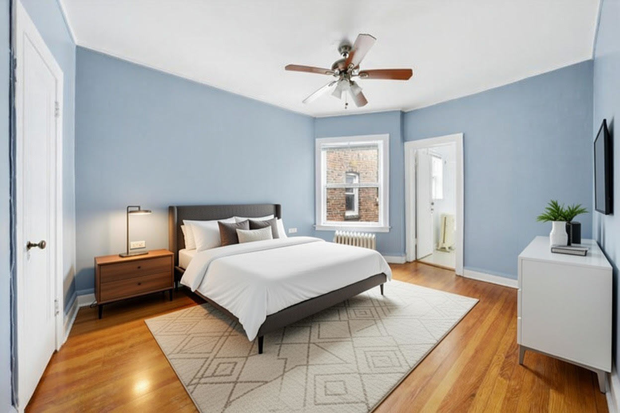 8019 South Rhodes Avenue Chicago, IL 60619 - Photo 24 of 55 a bedroom with a bed and a potted plant