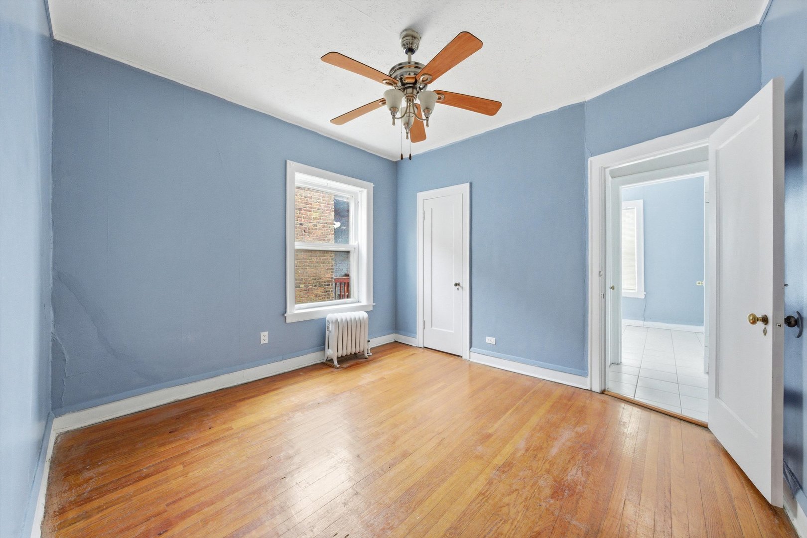 8019 South Rhodes Avenue Chicago, IL 60619 - Photo 26 of 55 a view of room with window and ceiling fan