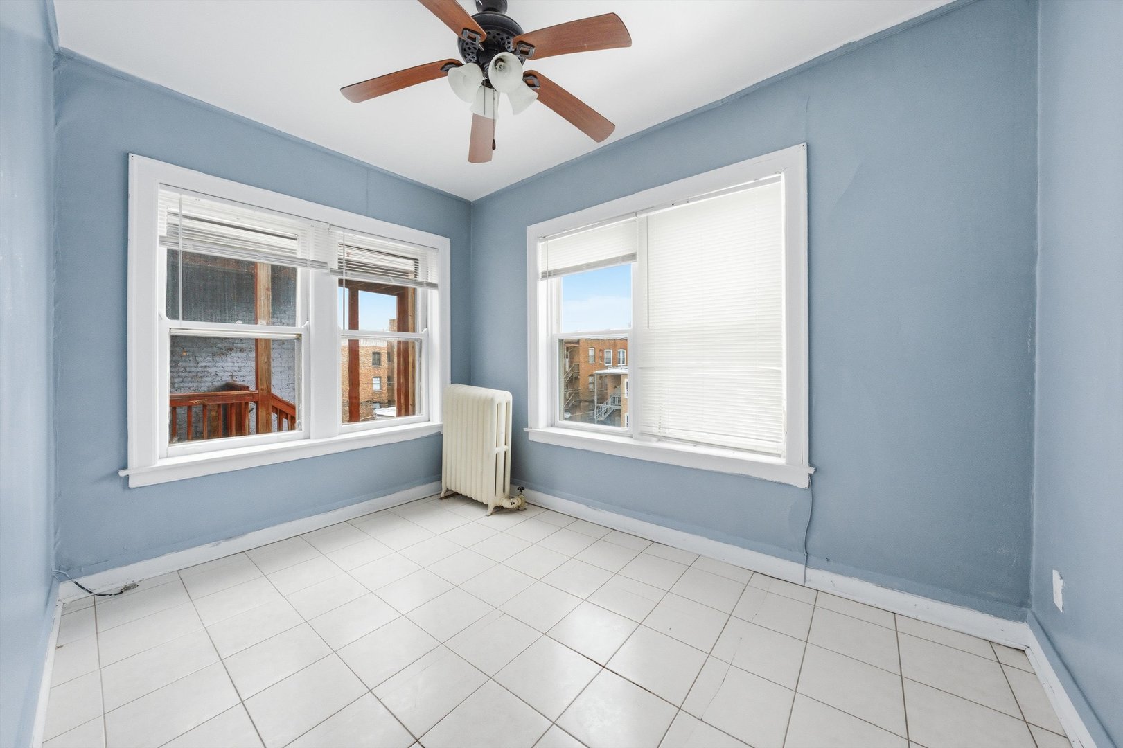 8019 South Rhodes Avenue Chicago, IL 60619 - Photo 28 of 55 an empty room with chandelier fan and windows