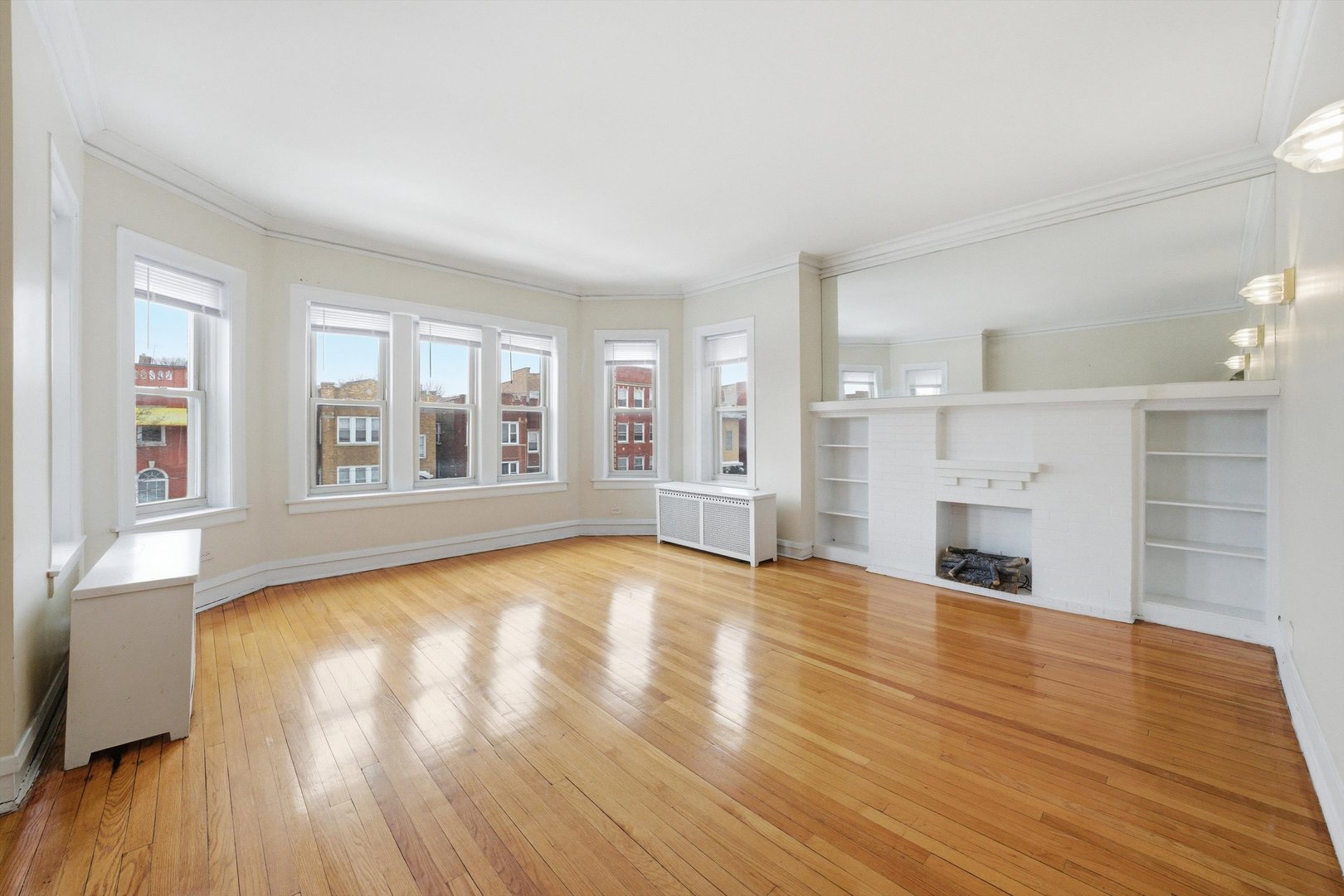 8019 South Rhodes Avenue Chicago, IL 60619 - Photo 30 of 55 a view of empty room with wooden floor and fireplace