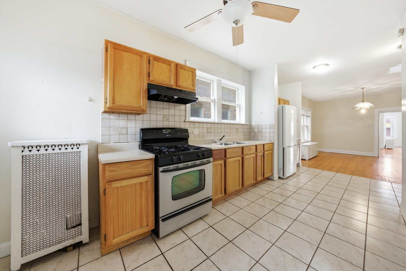 8019 South Rhodes Avenue Chicago, IL 60619 - Photo 33 of 55 a kitchen with stainless steel appliances granite countertop a stove a sink and a microwave