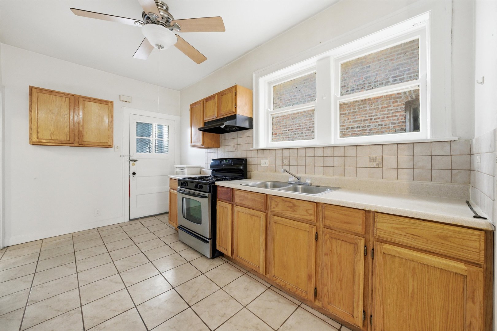 8019 South Rhodes Avenue Chicago, IL 60619 - Photo 34 of 55 a kitchen with a sink cabinets and window