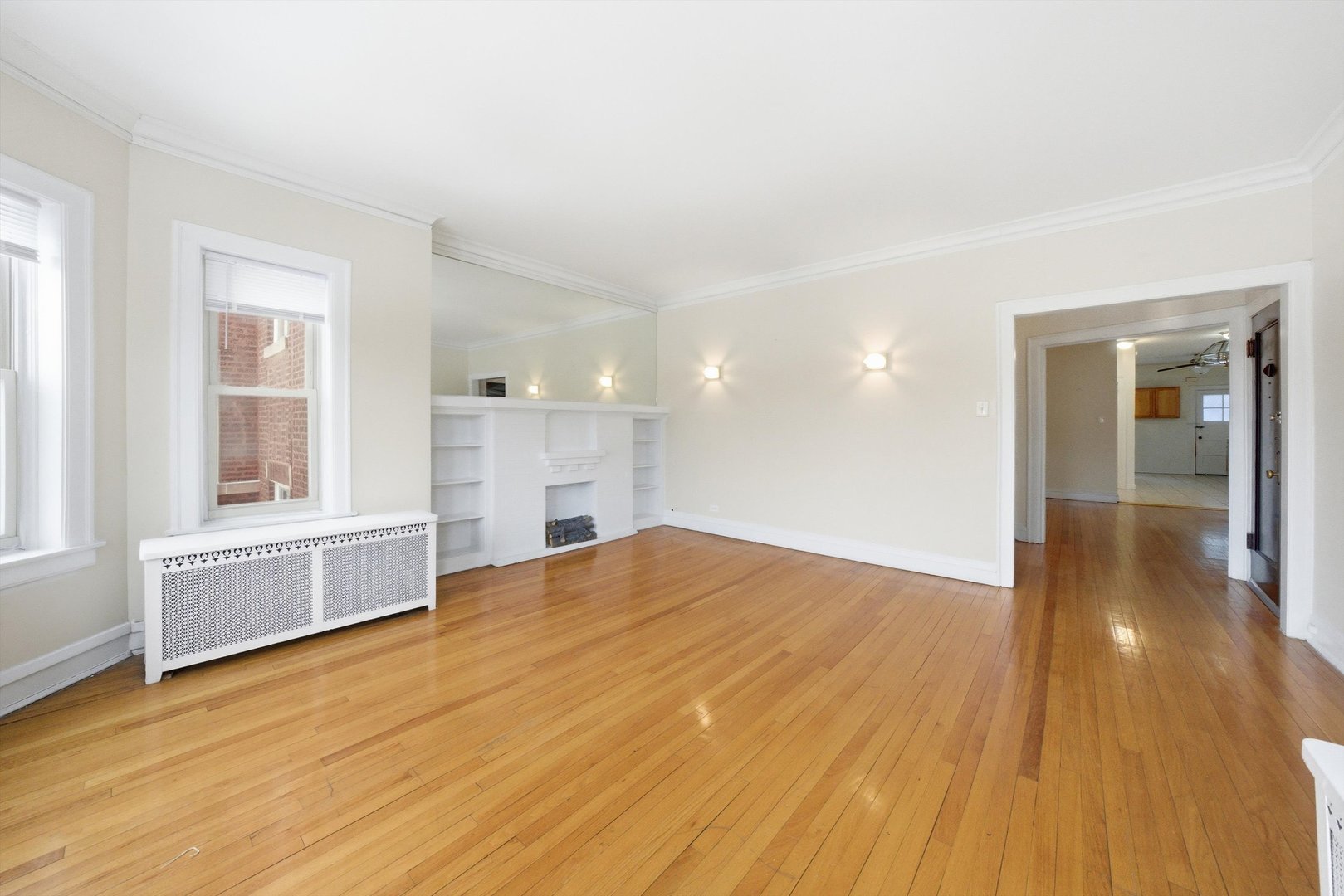 8019 South Rhodes Avenue Chicago, IL 60619 - Photo 36 of 55 a view of empty room with wooden floor and windows