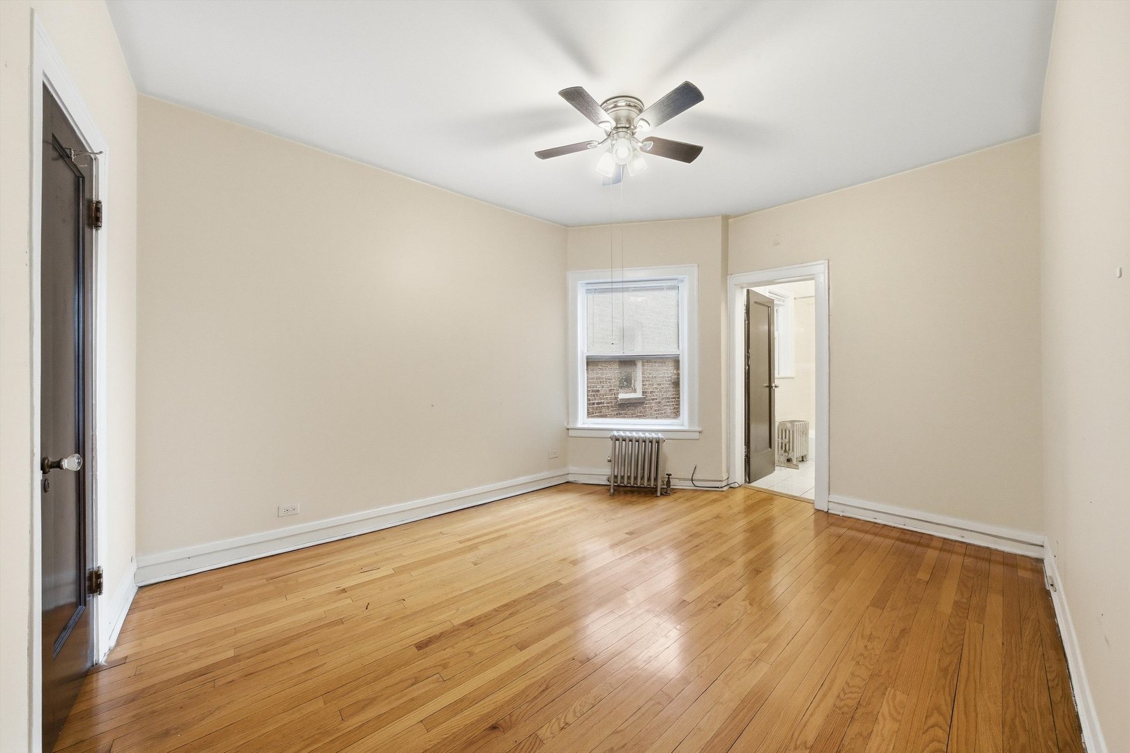 8019 South Rhodes Avenue Chicago, IL 60619 - Photo 38 of 55 a view of a room with a hardwood and ceiling fan