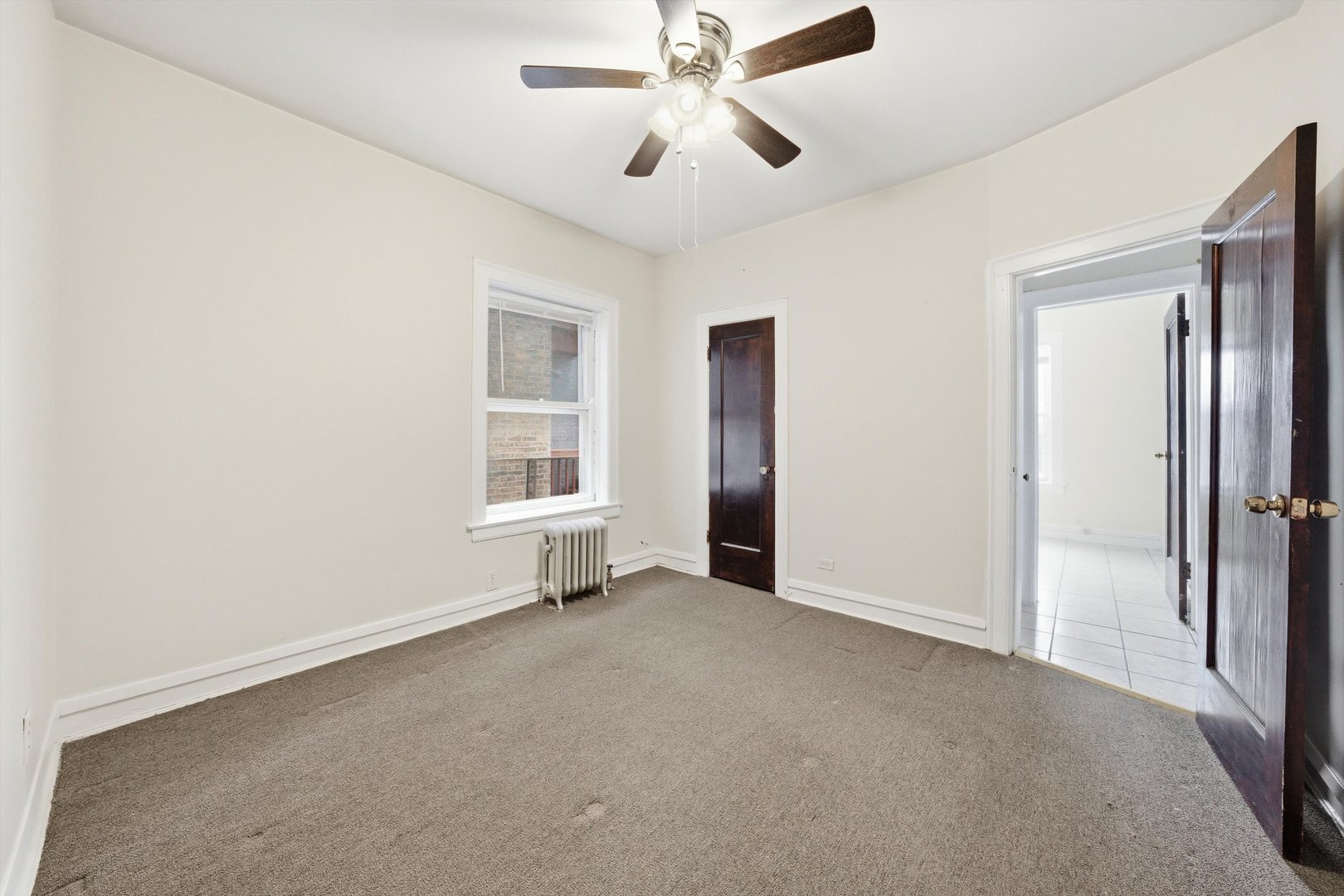 8019 South Rhodes Avenue Chicago, IL 60619 - Photo 39 of 55 a view of empty room with windows and ceiling fan