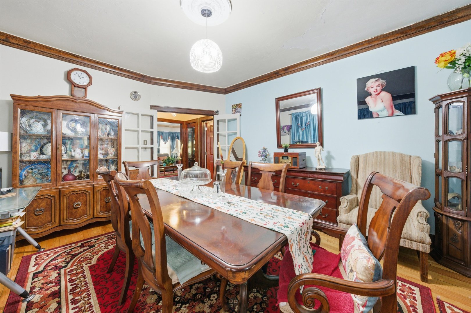 8019 South Rhodes Avenue Chicago, IL 60619 - Photo 7 of 55 a view of a dining room and livingroom with furniture wooden floor a rug and a large window