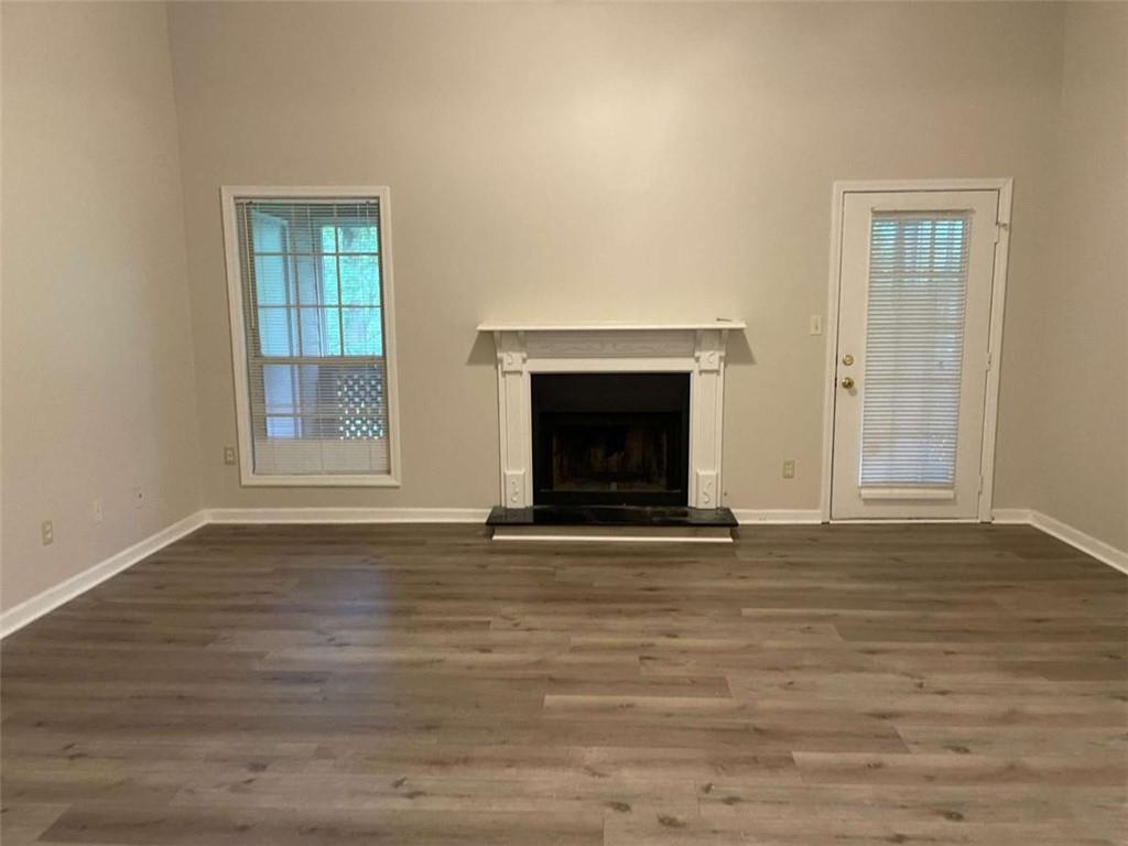 1514 Oakridge Court Decatur, GA 30033 - Photo 7 of 17 a view of an empty room with wooden floor fireplace and a window