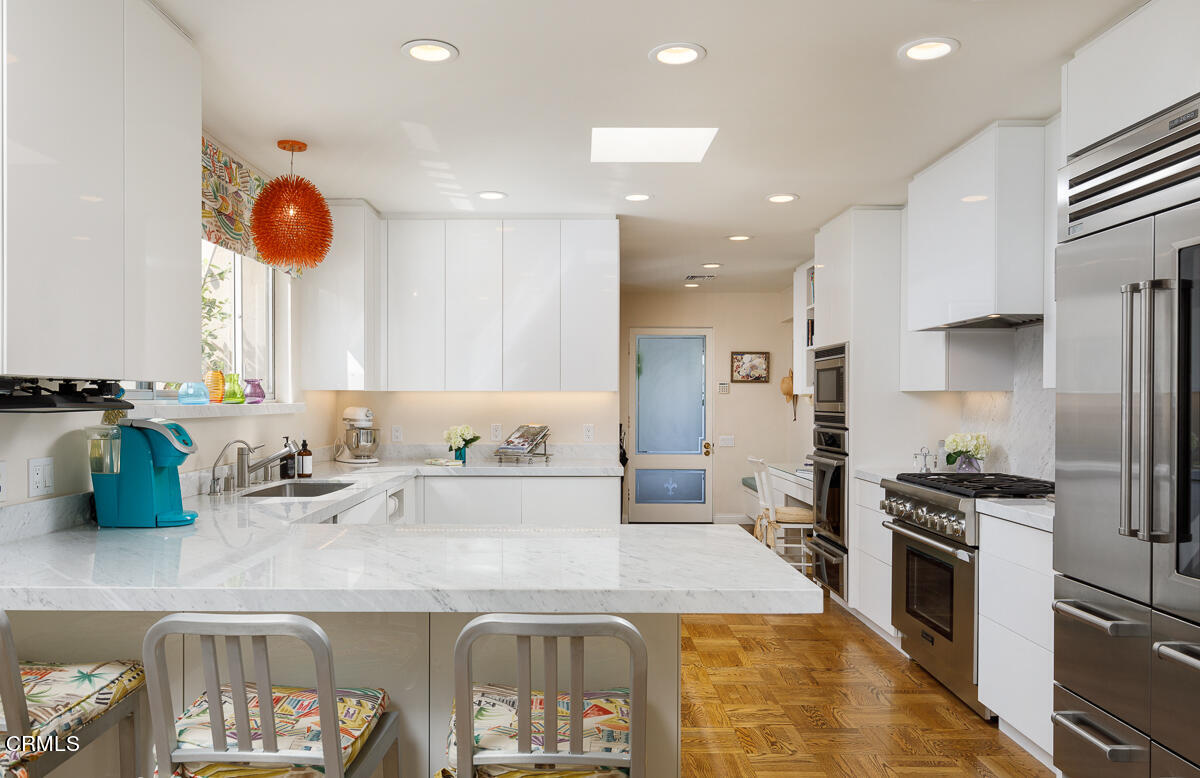 465 South San Rafael Avenue Pasadena, CA 91105 - Photo 21 of 75 a kitchen with stainless steel appliances granite countertop a sink a stove and a refrigerator