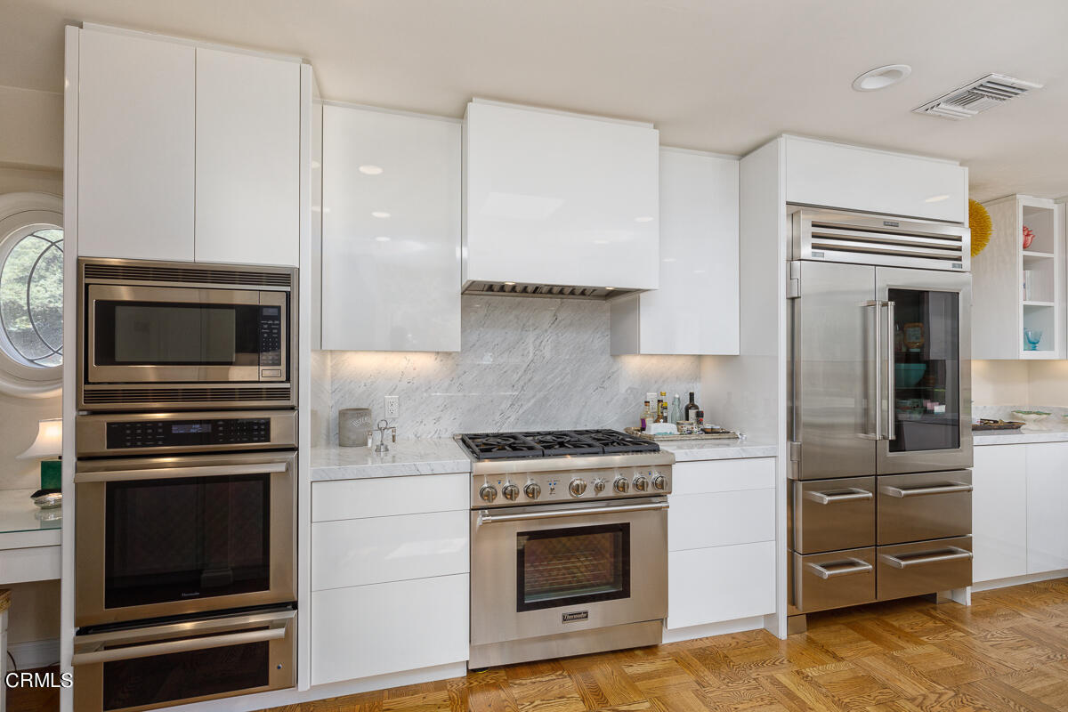 465 South San Rafael Avenue Pasadena, CA 91105 - Photo 23 of 75 a kitchen with cabinets and steel stainless steel appliances