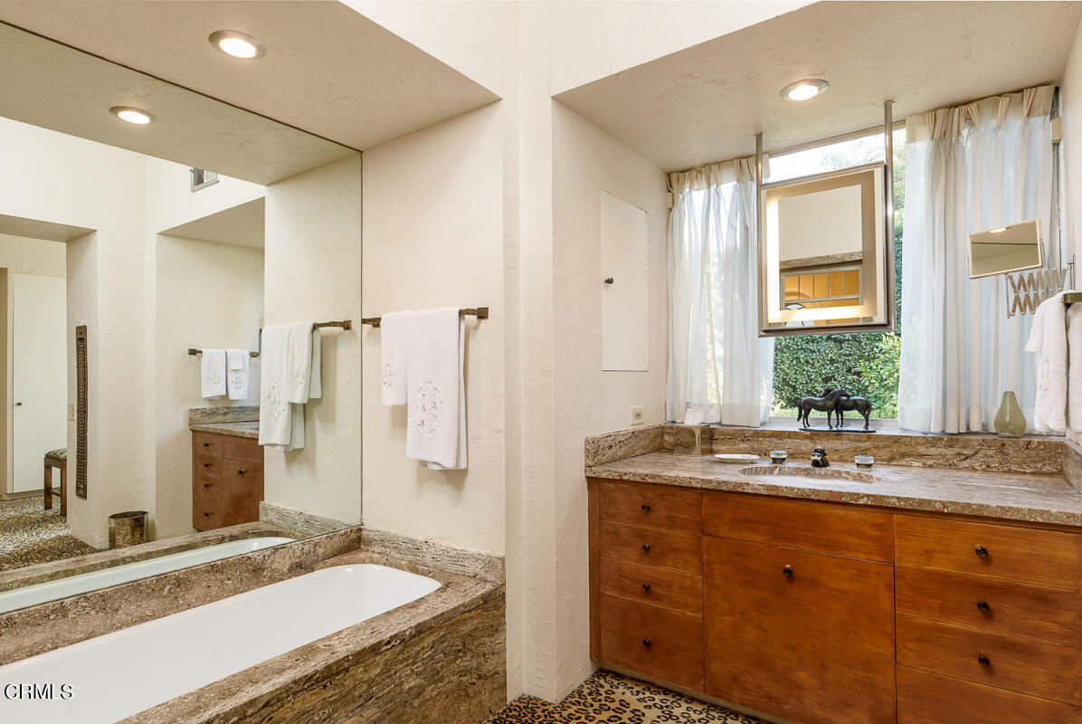 465 South San Rafael Avenue Pasadena, CA 91105 - Photo 32 of 75 a bathroom with a granite countertop sink mirror and double