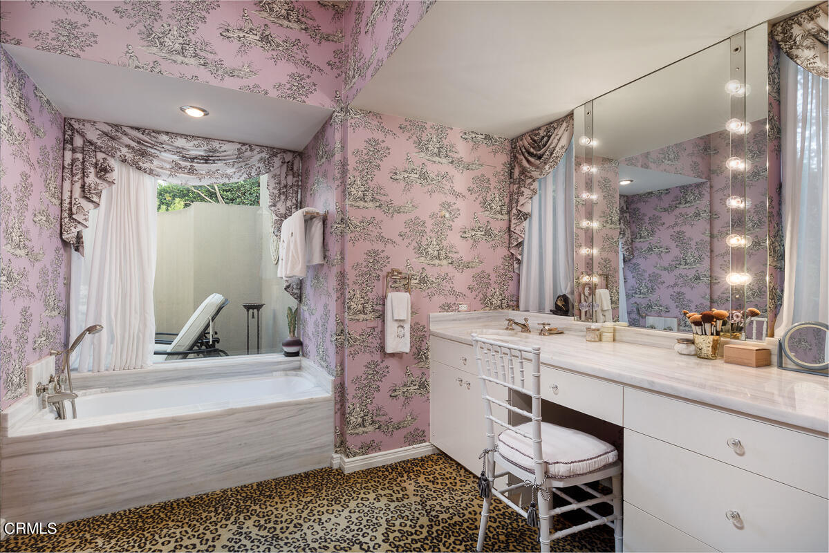 465 South San Rafael Avenue Pasadena, CA 91105 - Photo 38 of 75 a bathroom with a double vanity sink a mirror and a bathtub