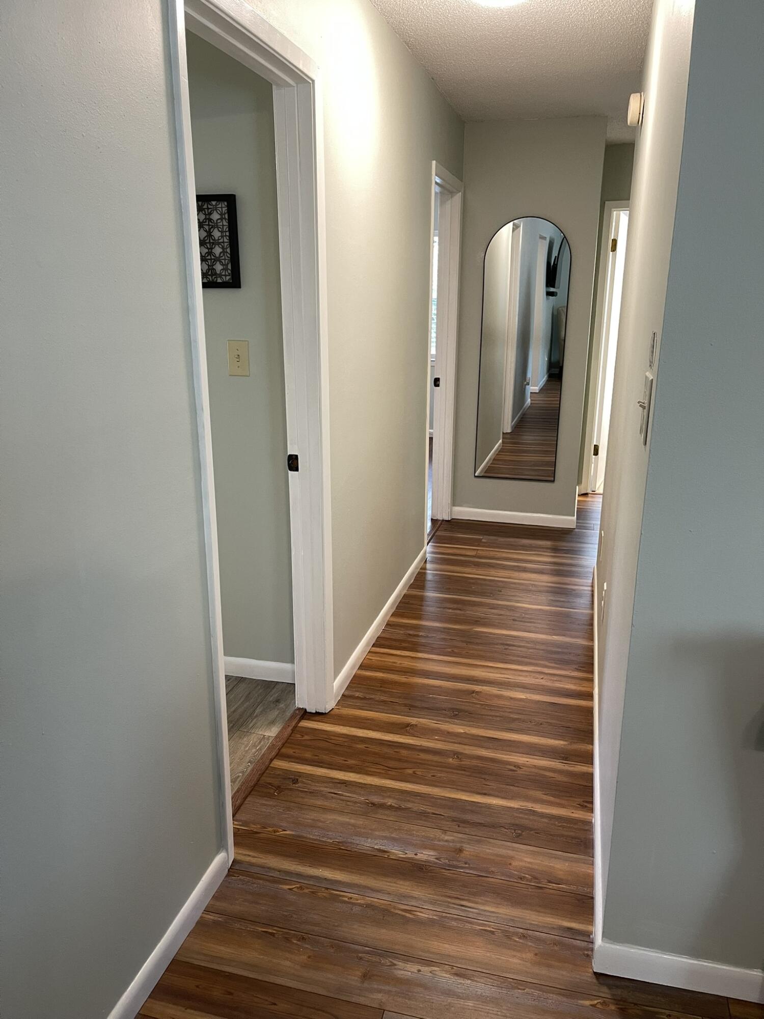 1086 County Highway 183 North DeFuniak Springs, FL 32433 - Photo 12 of 20 a view of a hallway with wooden floor and staircase