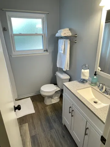 a bathroom with a sink a toilet and a mirror